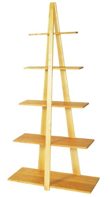 A tall bookcase of light wood, five cantilevered shelves narrowing toward the top like the bow of a boat